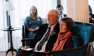 David Blocher, Volunteer of the Year award recipient, and his wife listen as the Home Care and Hospice Alliance of Maine reads his nomination.